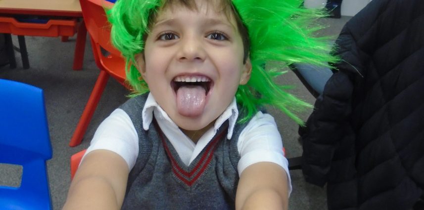 a boy with a green wig