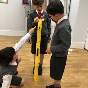 children using a giant ruler