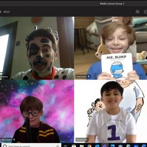 Four school boys in a Zoom call dressed up, one as a Dalmatian, one as Mr. Bump, one as Harry Potter and one as a footballer.